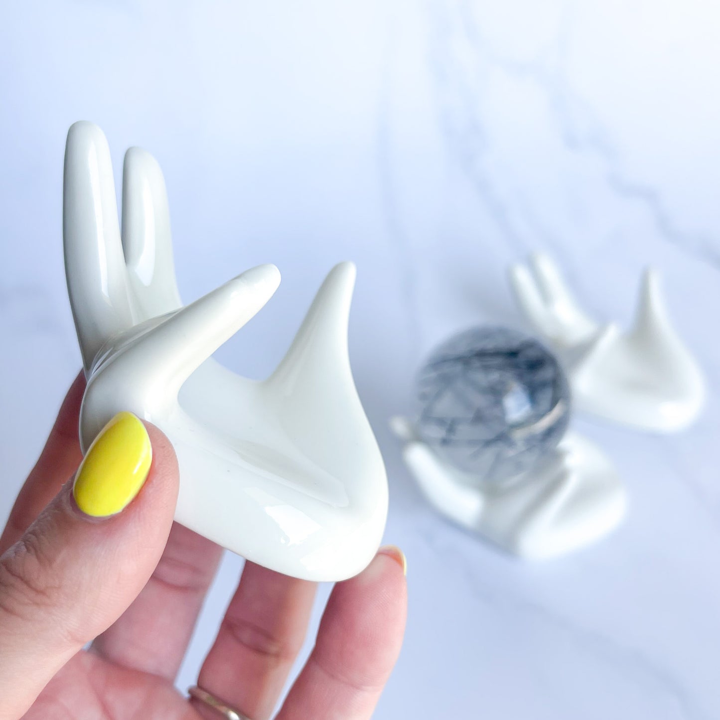 White Ceramic Sphere Holding Hands